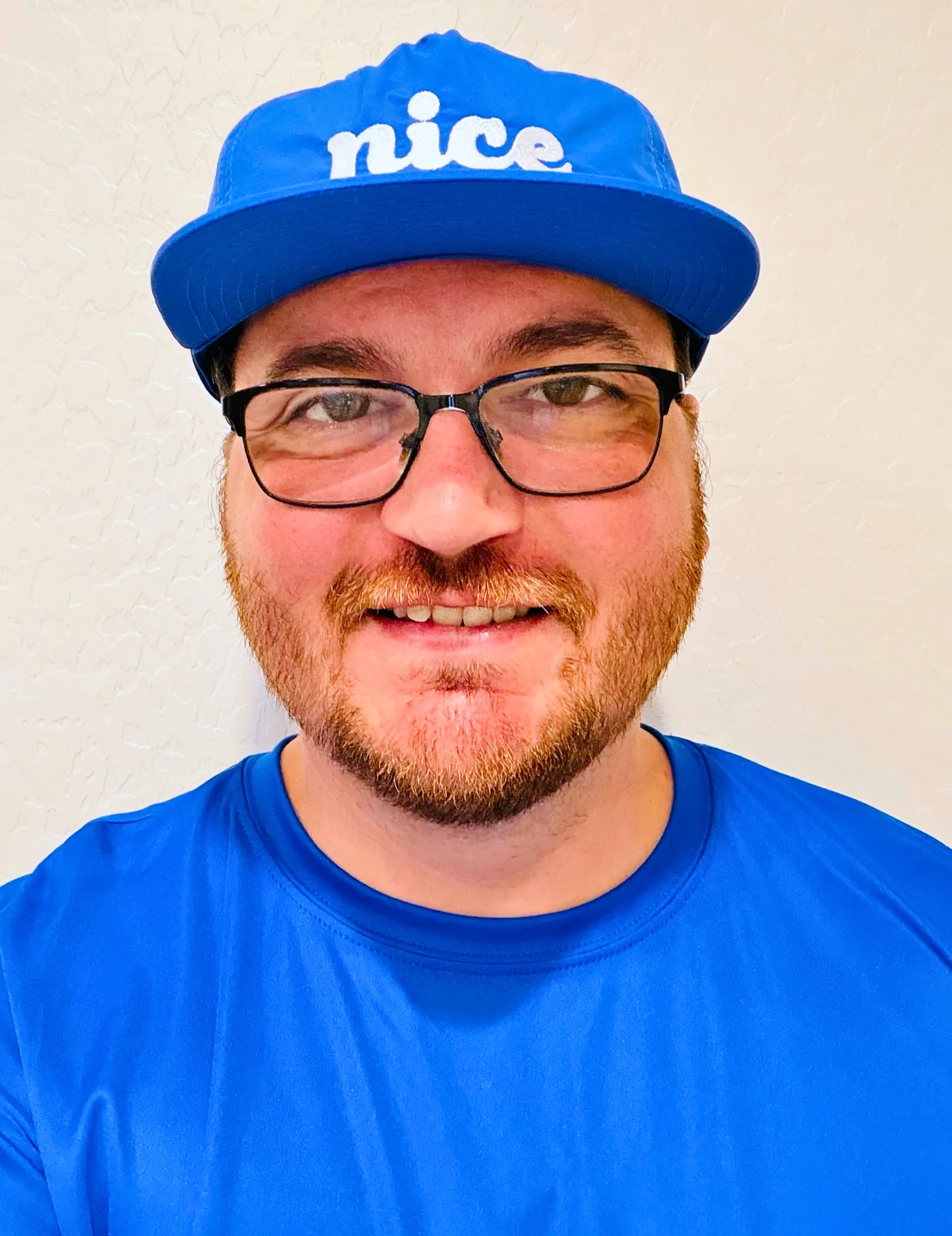 Brandon Johnstun wearing a blue Nice Pest Company shirt and cap