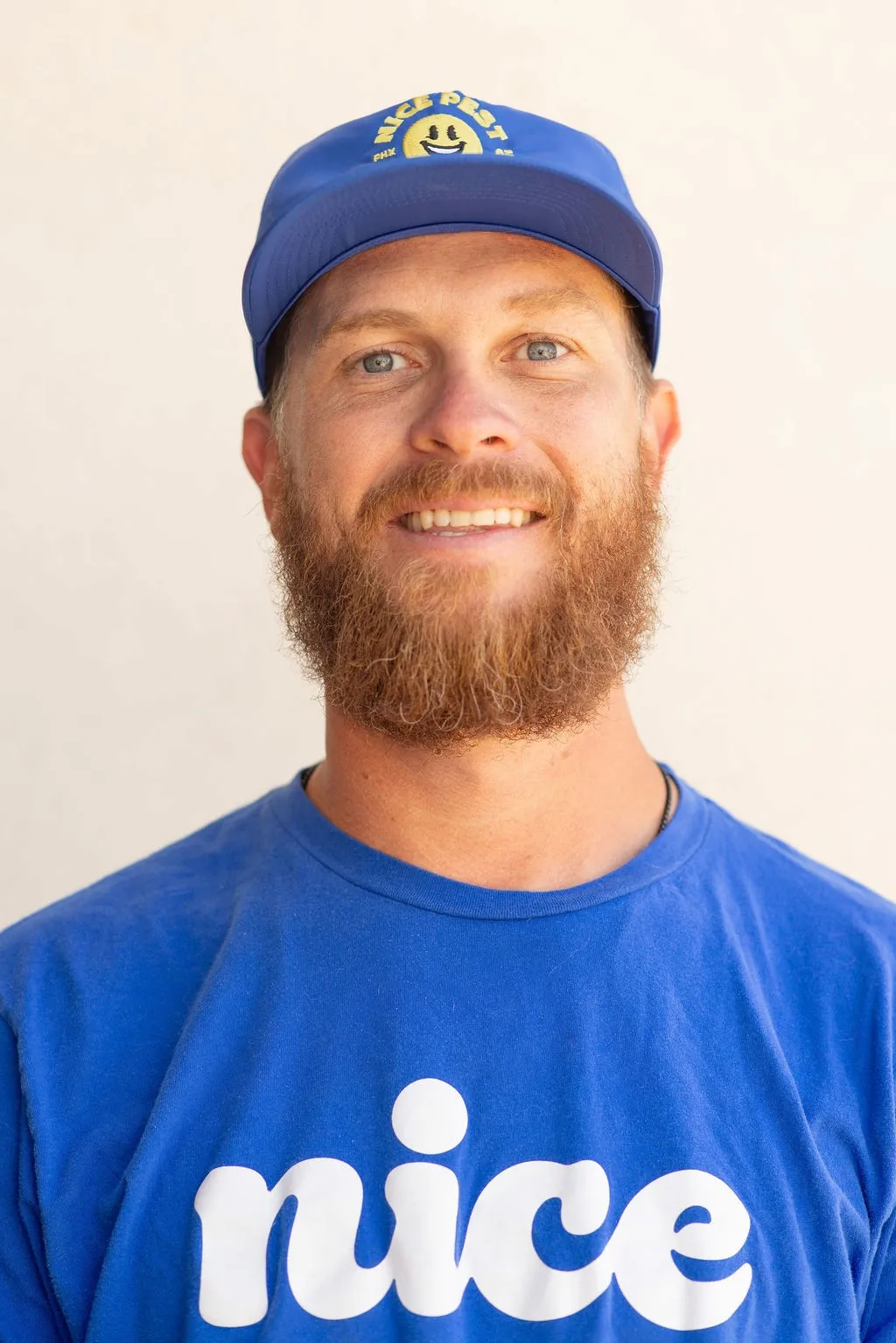 Jared Schroer wearing a blue Nice Pest Company shirt and cap