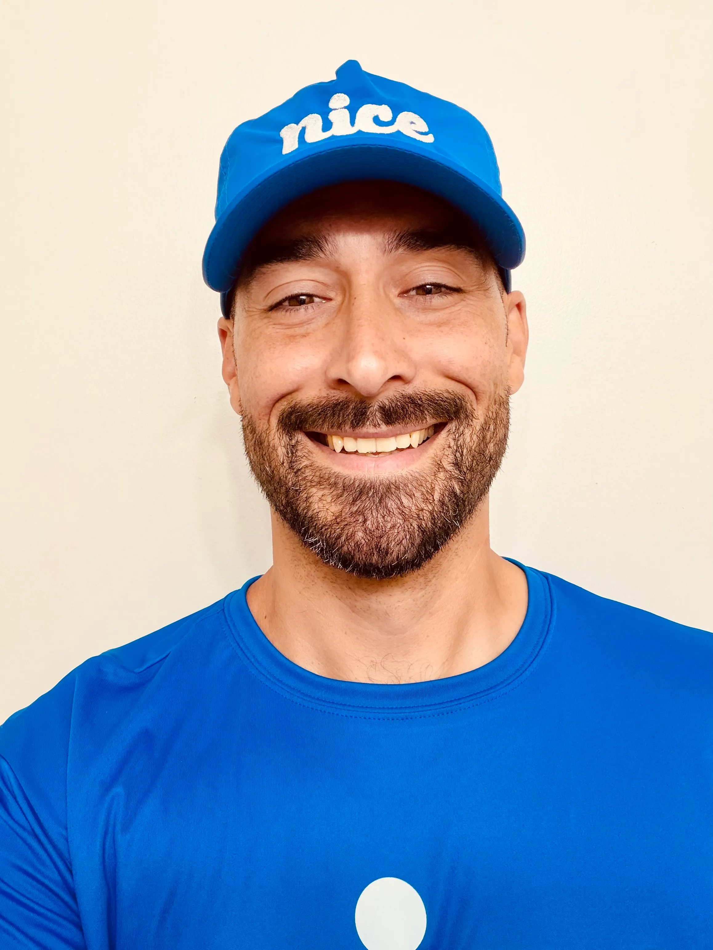 Shon Roe wearing a blue Nice Pest Company shirt and cap