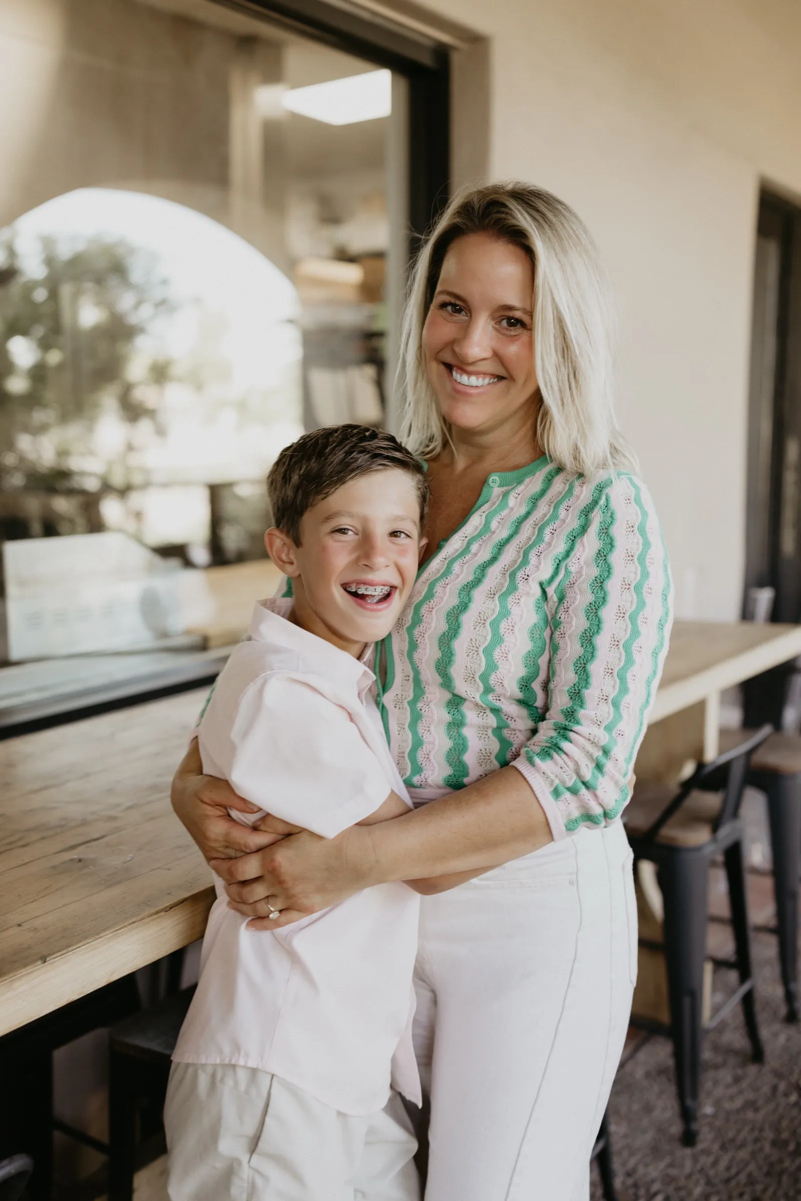 Stacey Weber hugging her son Jack inside Amelia's by EAT in McCormick Ranch